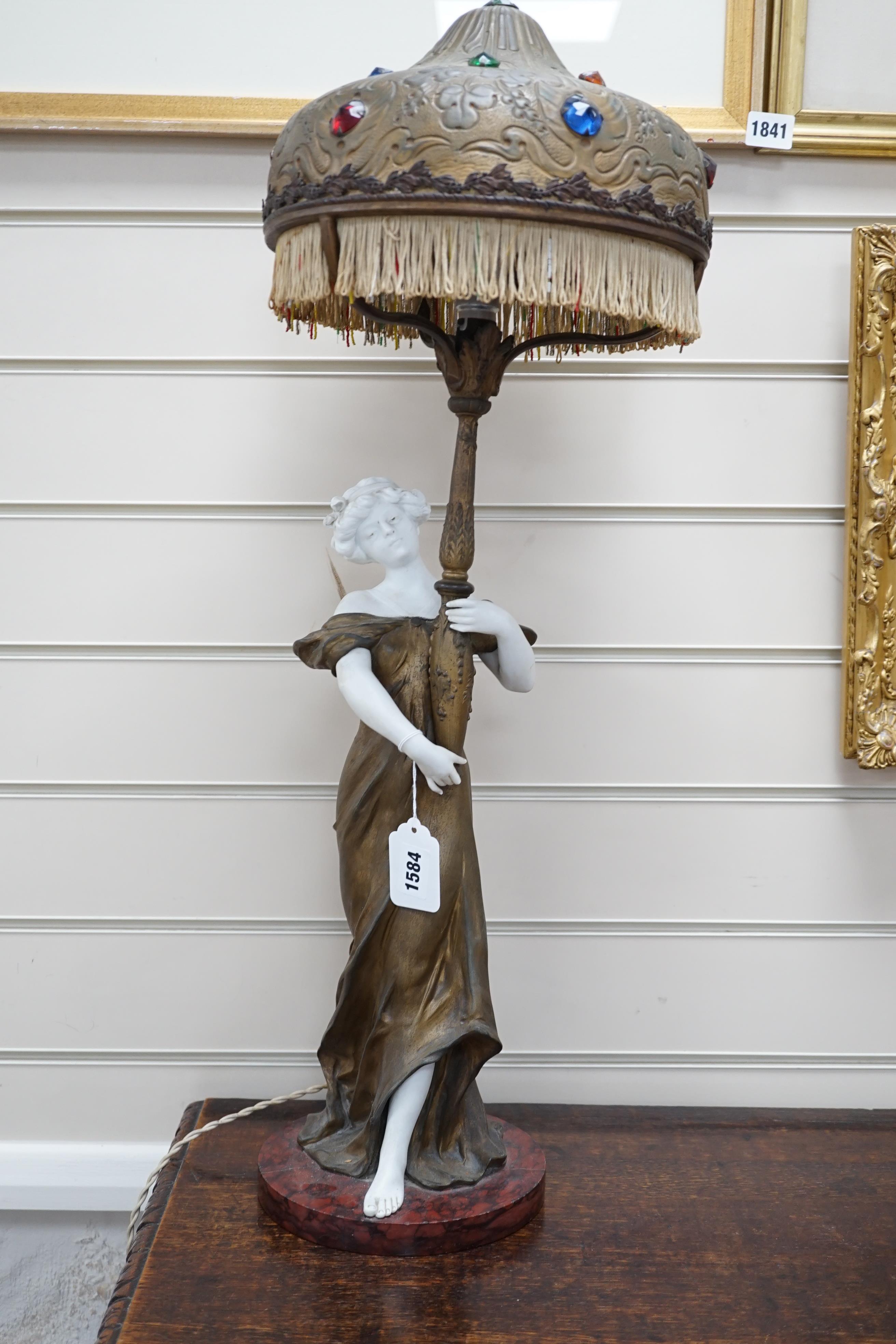 An Art Nouveau gilt-spelter and bisque figural table lamp, on rouge marble base, jewelled gilt-spelter shade, 73cm tall
